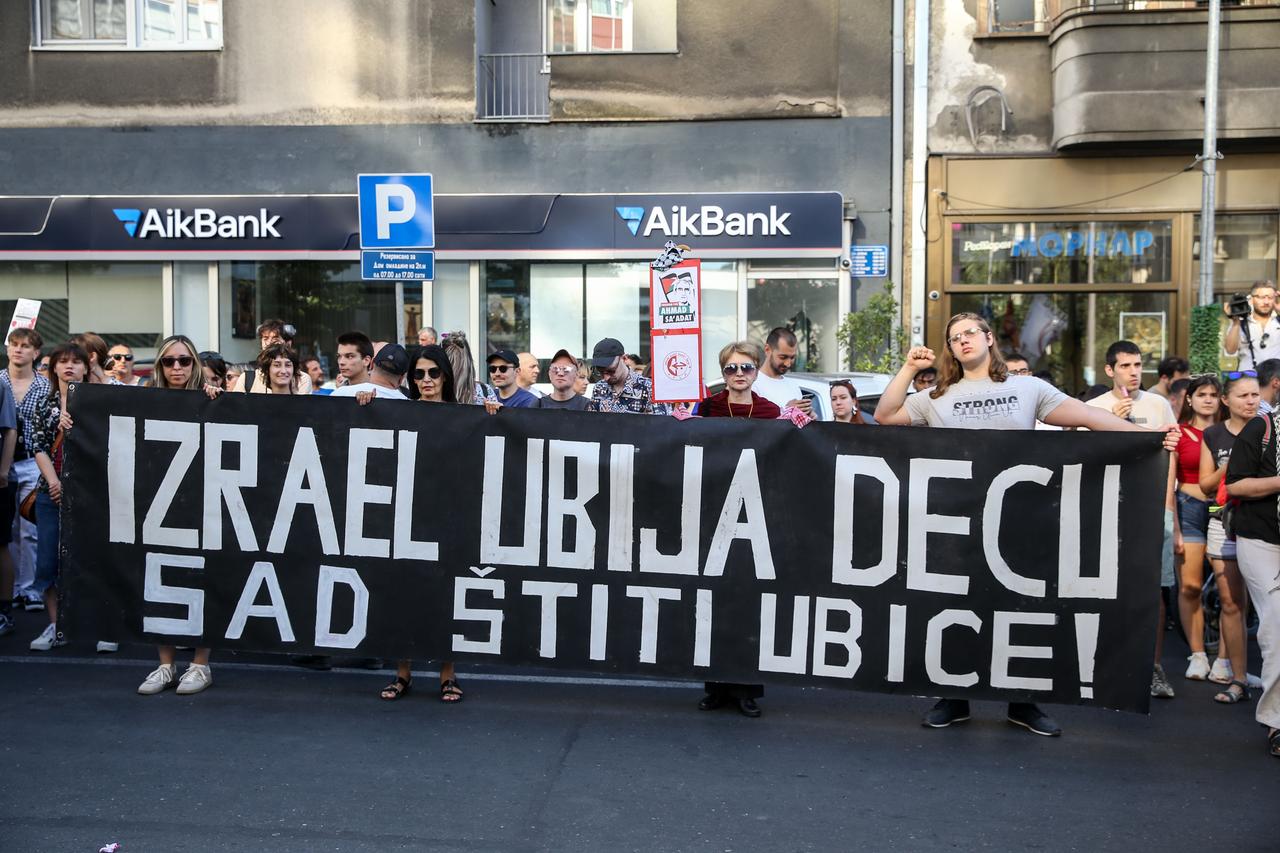 People protest against Serbia's arms aid to Israel, gathered in the square near the Student Cultural Center, holding a banner that reads "Israel kills children, now it protects the killers," in Belgrade, Serbia on June 22, 2025.  (AA Photo)