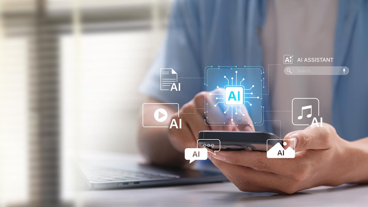 A person uses a smartphone surrounded by AI-powered tool icons, representing the expanding role of artificial intelligence in everyday digital life. (Adobe Stock Photo)