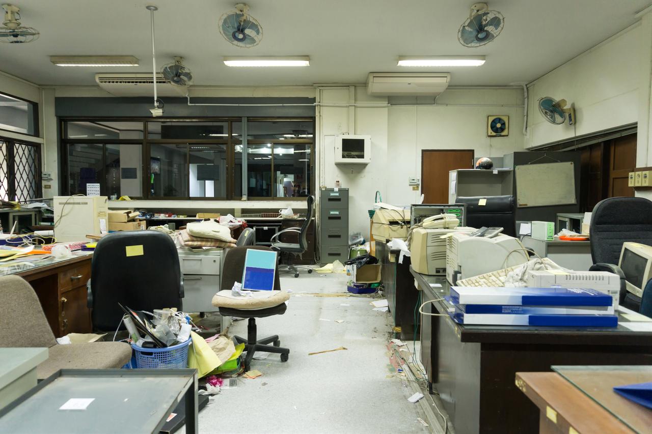 An abandoned office filled with outdated equipment and scattered clutter reflects the rapid pace at which workplaces can become obsolete. (Adobe Stock Photo)