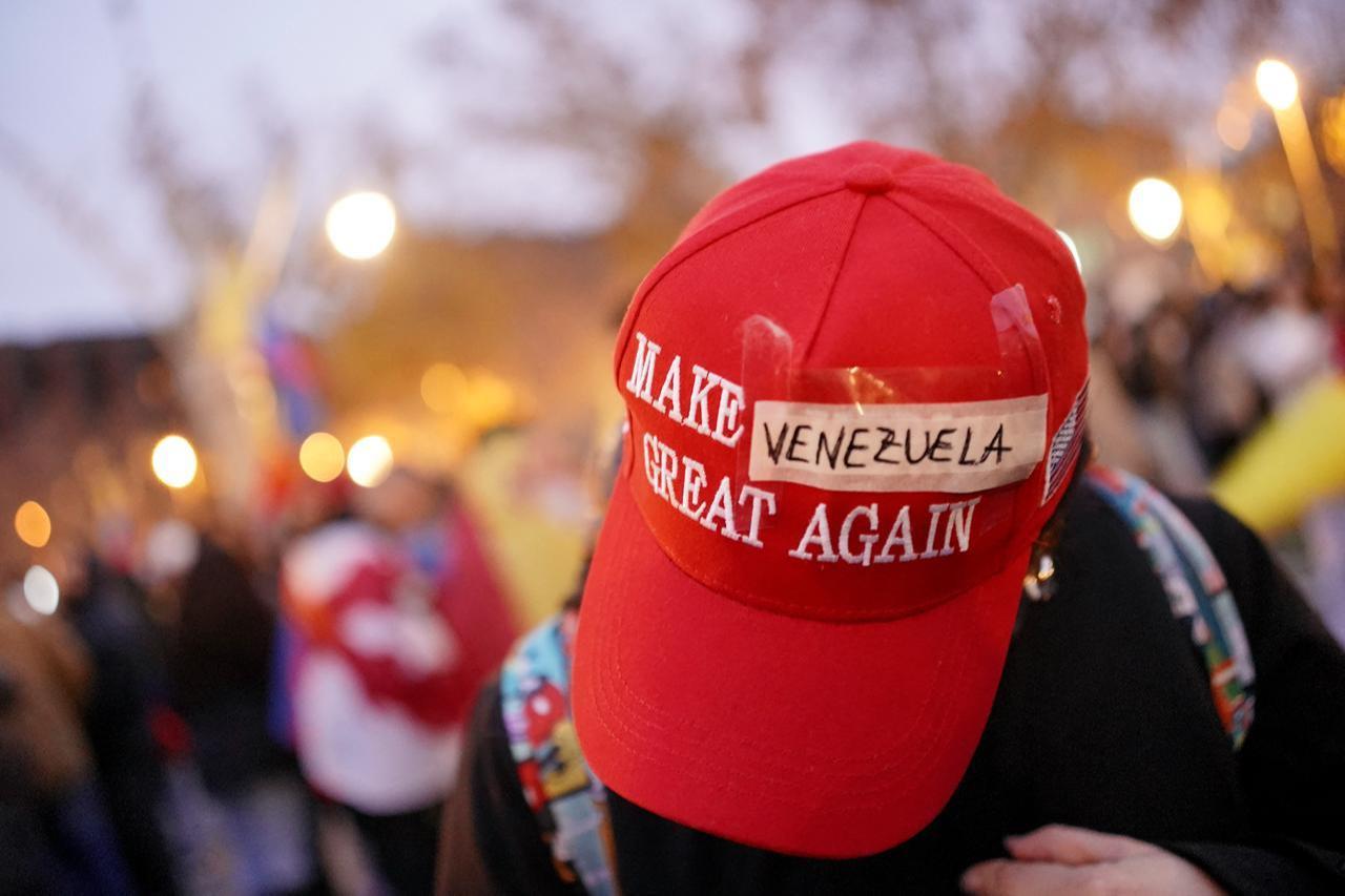 A protester wears a modified Make America Great Again (MAGA) hat with Venezuela taped over the original text during a demonstration in support of the Venezuelan people following the US military operation in Venezuela to capture the Venezuelan president, in Barcelona on Jan. 4, 2026. (AFP Photo)
