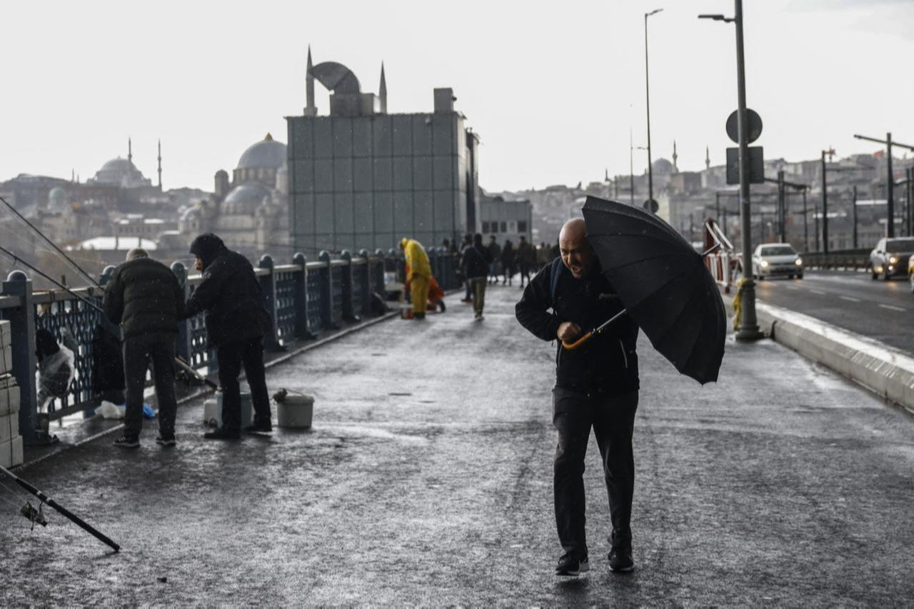 A man forced to walk in rainy and windy weather in Istanbul, Türkiye, November 21, 2024. (AFP Photo)