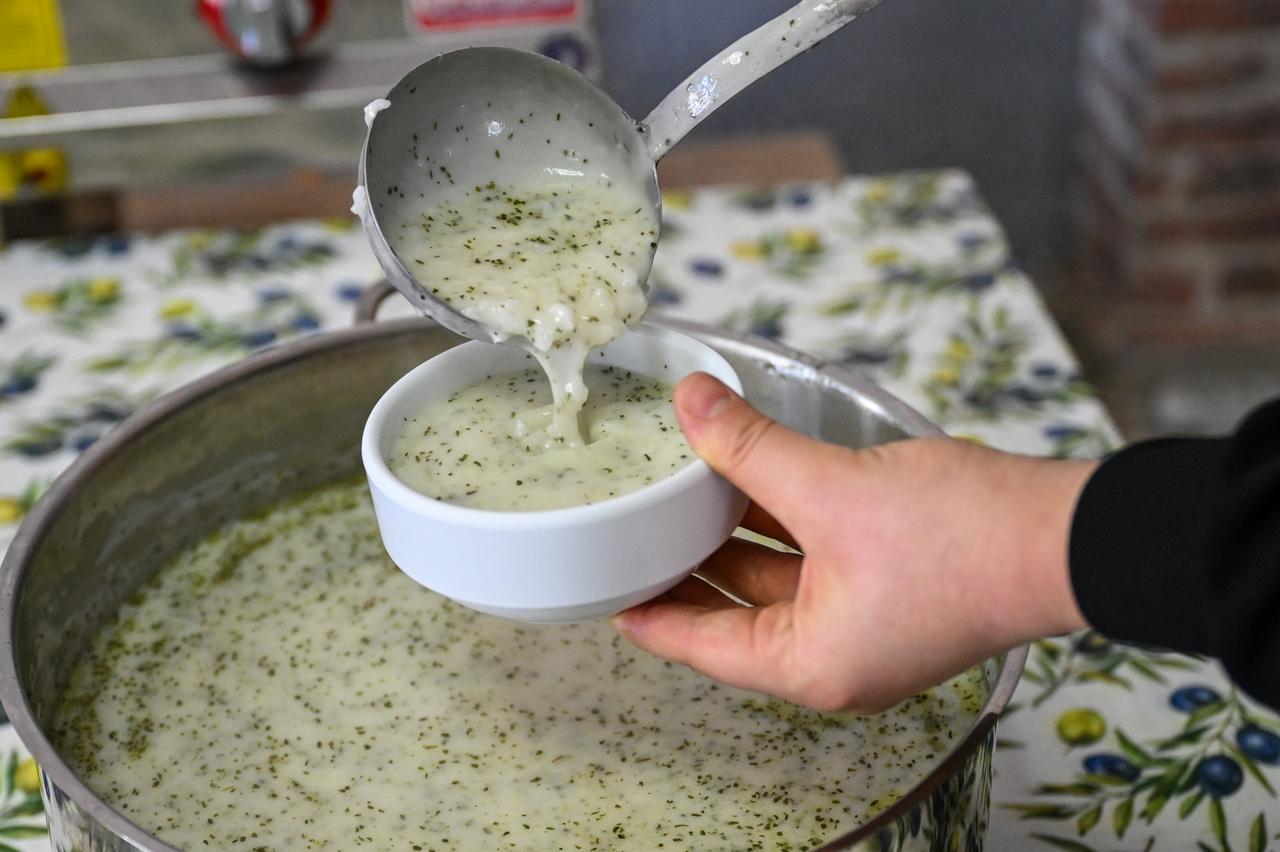 Salted yogurt soup is ladled into a bowl after cooking in Hatay, Türkiye, March 2, 2026. (AA Photo)