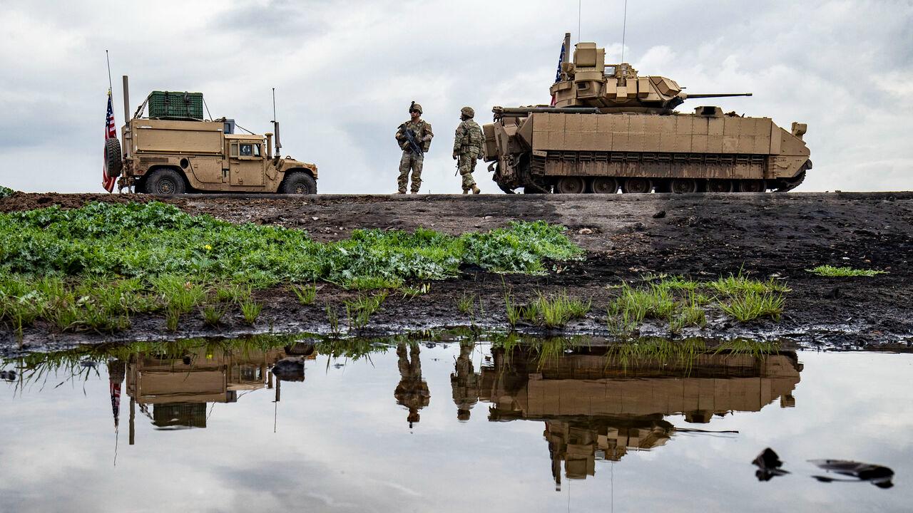 US army soldiers stand near armoured military vehicles on the outskirts of Rumaylan in Syria's northeastern Hasakah province, bordering Türkiye, March 27, 2023. (AFP Photo)
