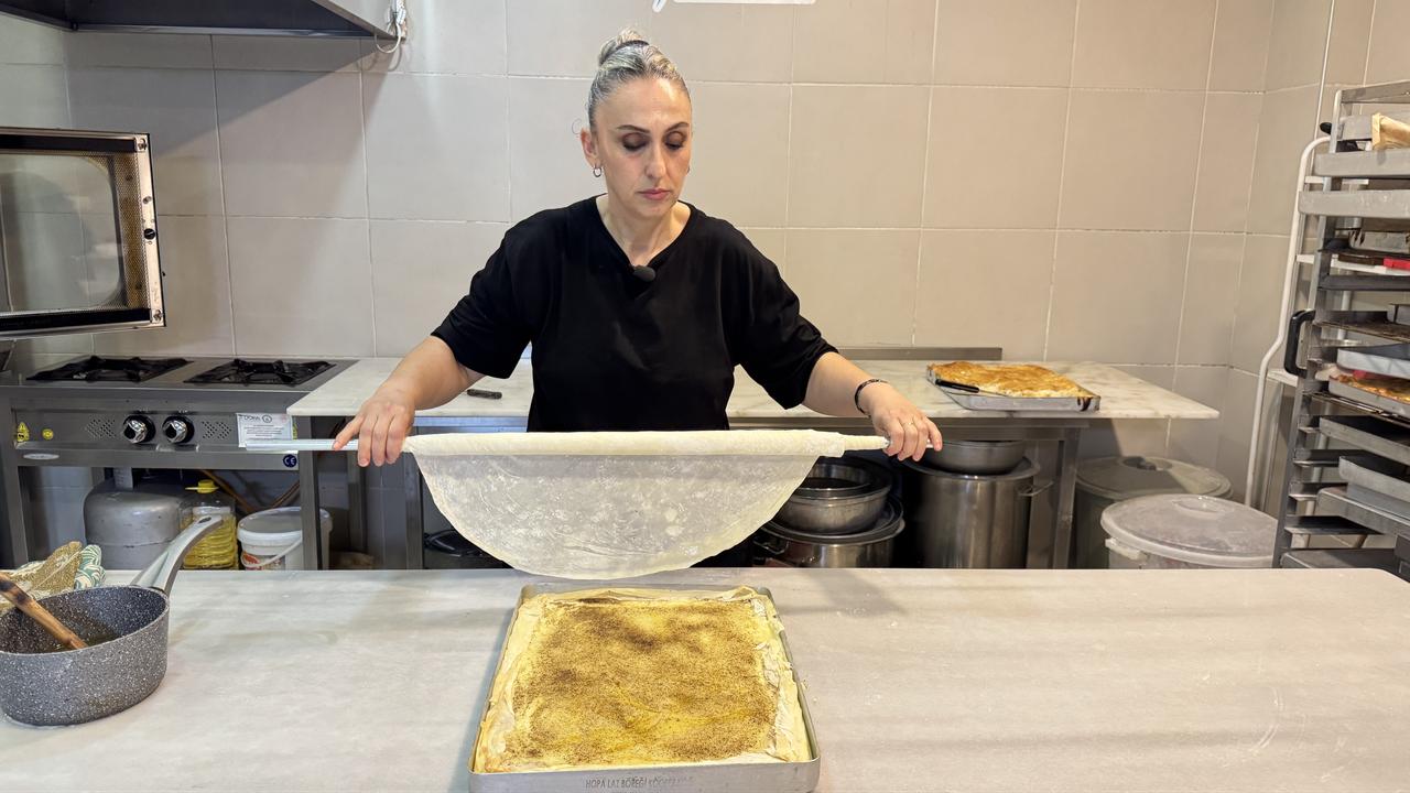 A thin pastry layer is placed over the custard filling during Laz boregi preparation in Hopa, Artvin, Türkiye, March 1, 2026. (AA Photo)