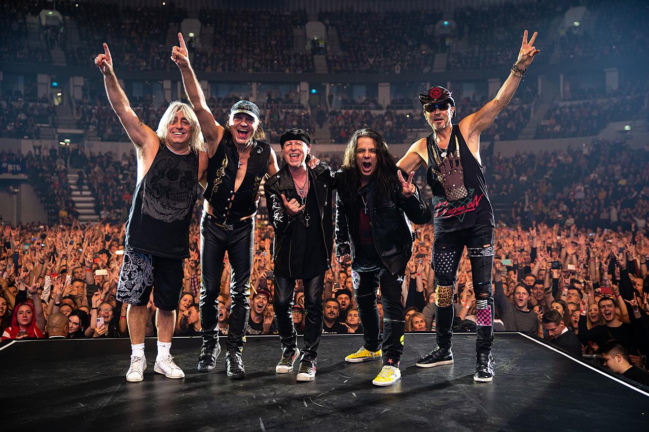Members of Scorpions greet the audience during a live stadium performance. (Courtesy of BKM)