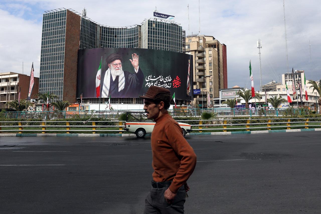 A man walks past a billboard of Iran’s supreme leader Ali Khamenei in Tehran on March 2, 2026. (AFP Photo)