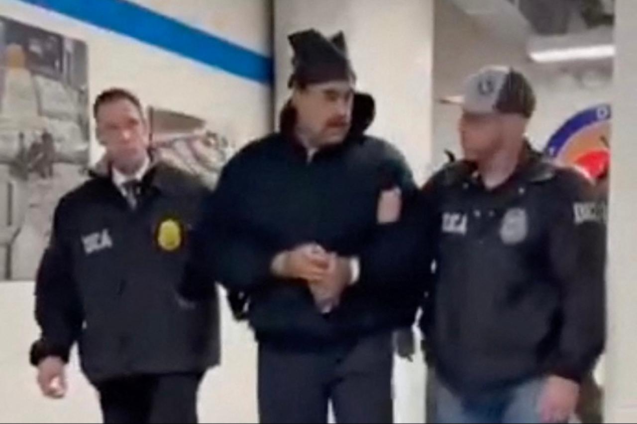 This screengrab shows Venezuelan President Nicolas Maduro (C) escorted by DEA agents inside the headquarters of the US Drug Enforcement Administration (DEA) in lower Manhattan, New York, January 3, 2026. (Photo via X/@RapidResponse47)