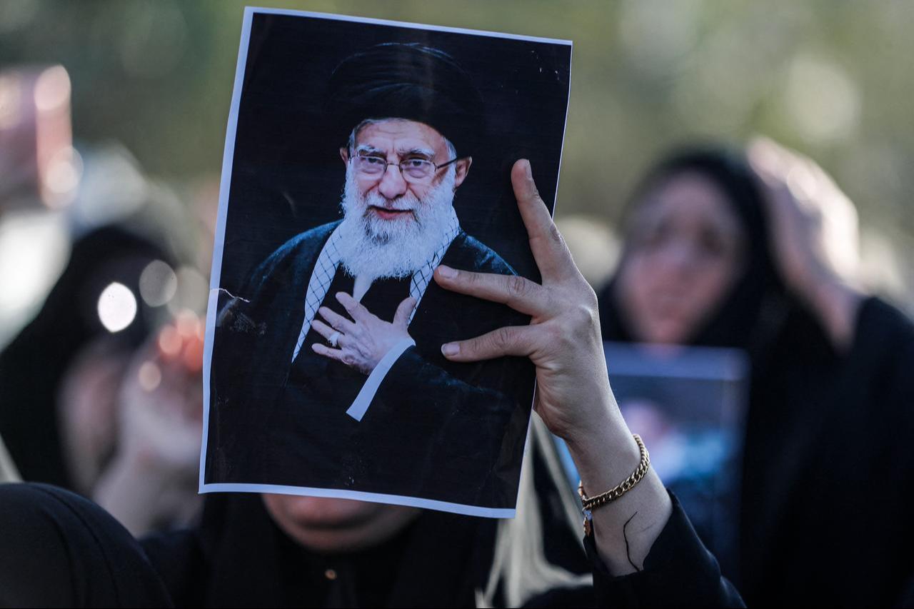 An Iraqi Shiites Muslim woman holds up the image of killed Iranian supreme leader Ayatollah Ali Khamenei, during a symbolic funeral the day after his assassination, in the district of Sadr City, in Baghdad, Iraq on March 1, 2026. (AFP Photo)