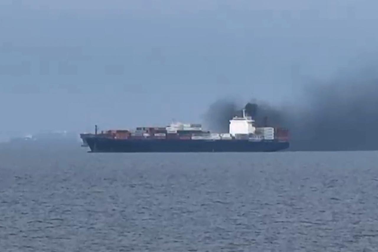Frame grab shows smoke emerging from the Source Blessing cargo vessel, as filmed from the vessel Wang was onboard in the Gulf, north of Dubai, Mar. 12, 2026. (AFP Photo)