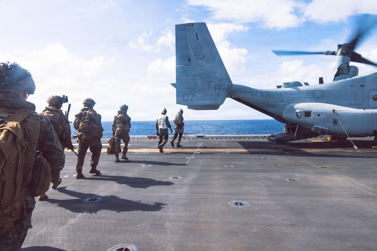 U.S. Marines loads onto an MV-22B Osprey aboard the forward-deployed amphibious assault carrier USS Tripoli (LHA 7), Dec. 14, 2025, (Photo via U.S. Marine Corps)