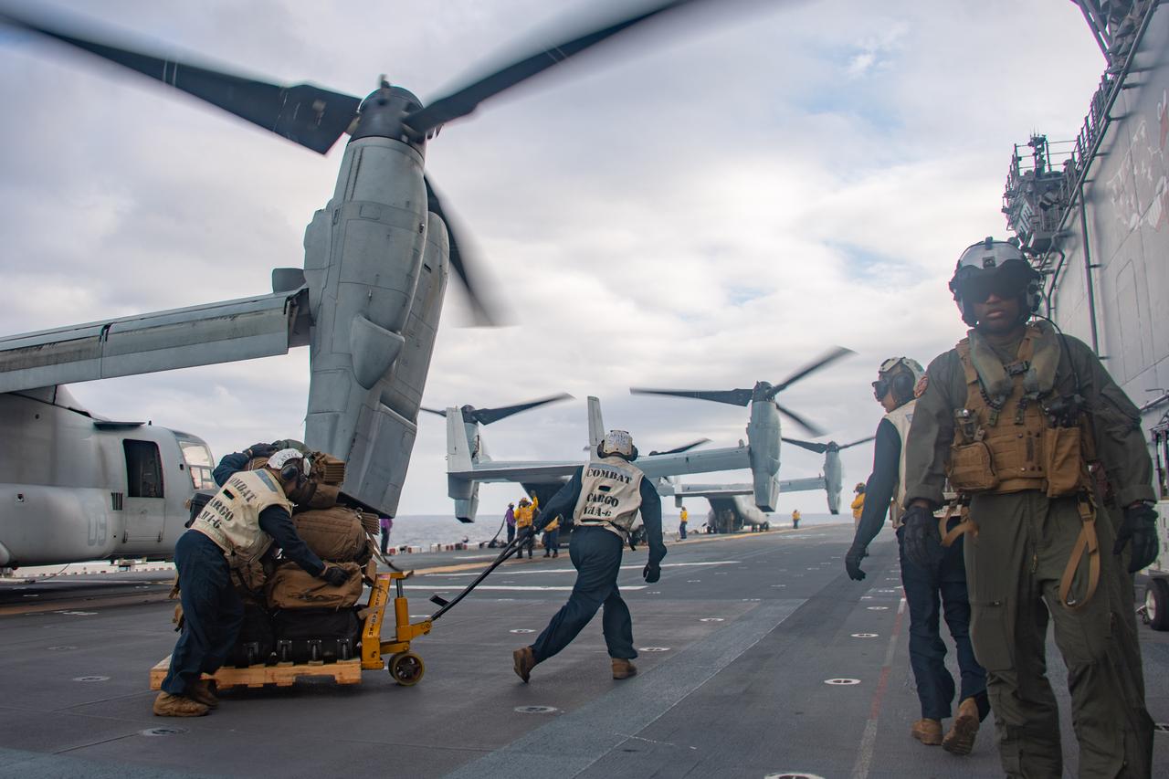 Marines aboard the forward-deployed amphibious assault ship USS America (LHA 6) transport cargo from an MV-22B Osprey tiltrotor aircraft in the Philippine Sea, Jan. 24, 2025. (Photo via U.S. Navy)