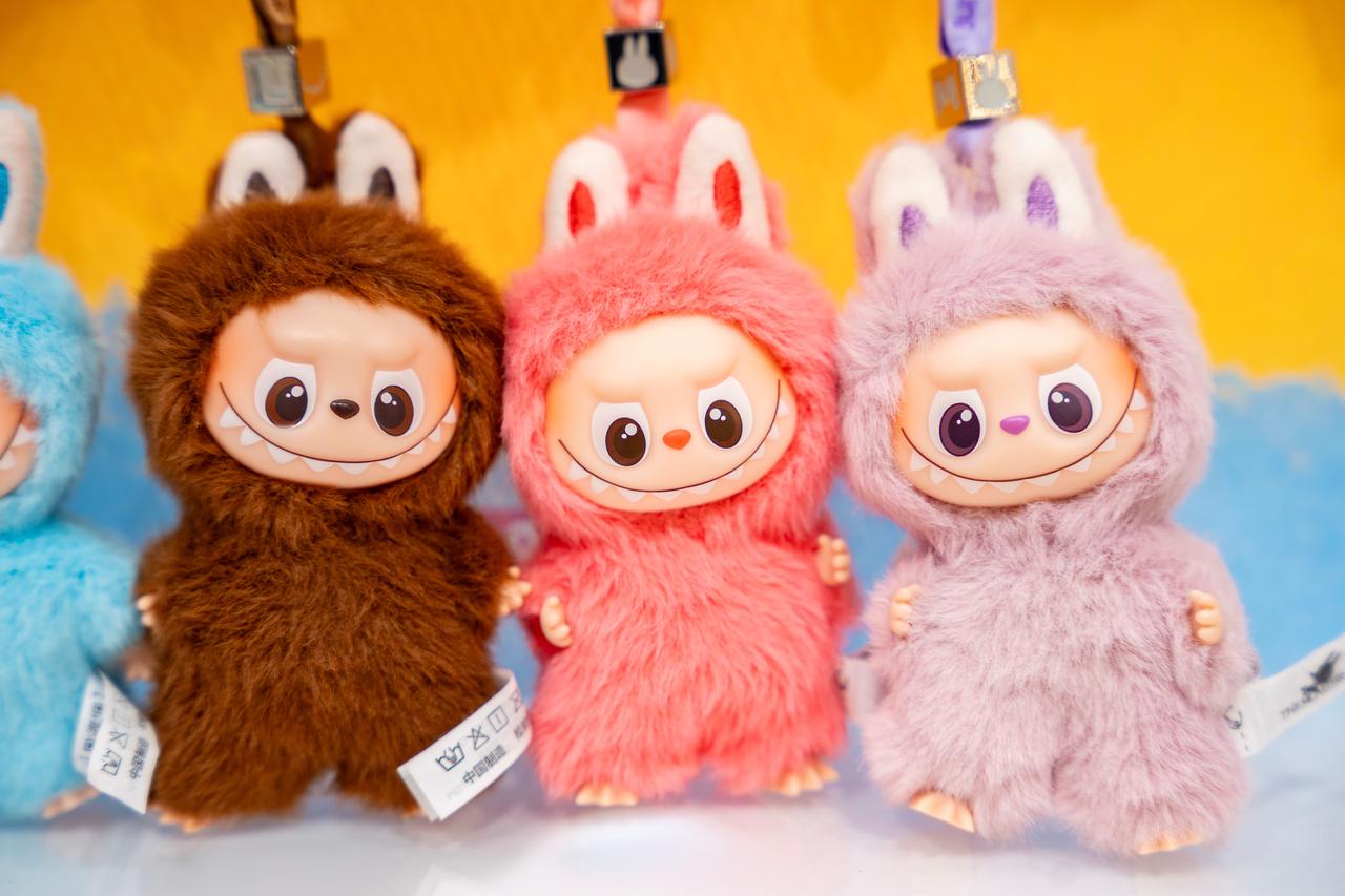 A collection of Labubu macaron-themed art toy keychains from Pop Mart blind boxes on display. (Adobe Stock Photo)