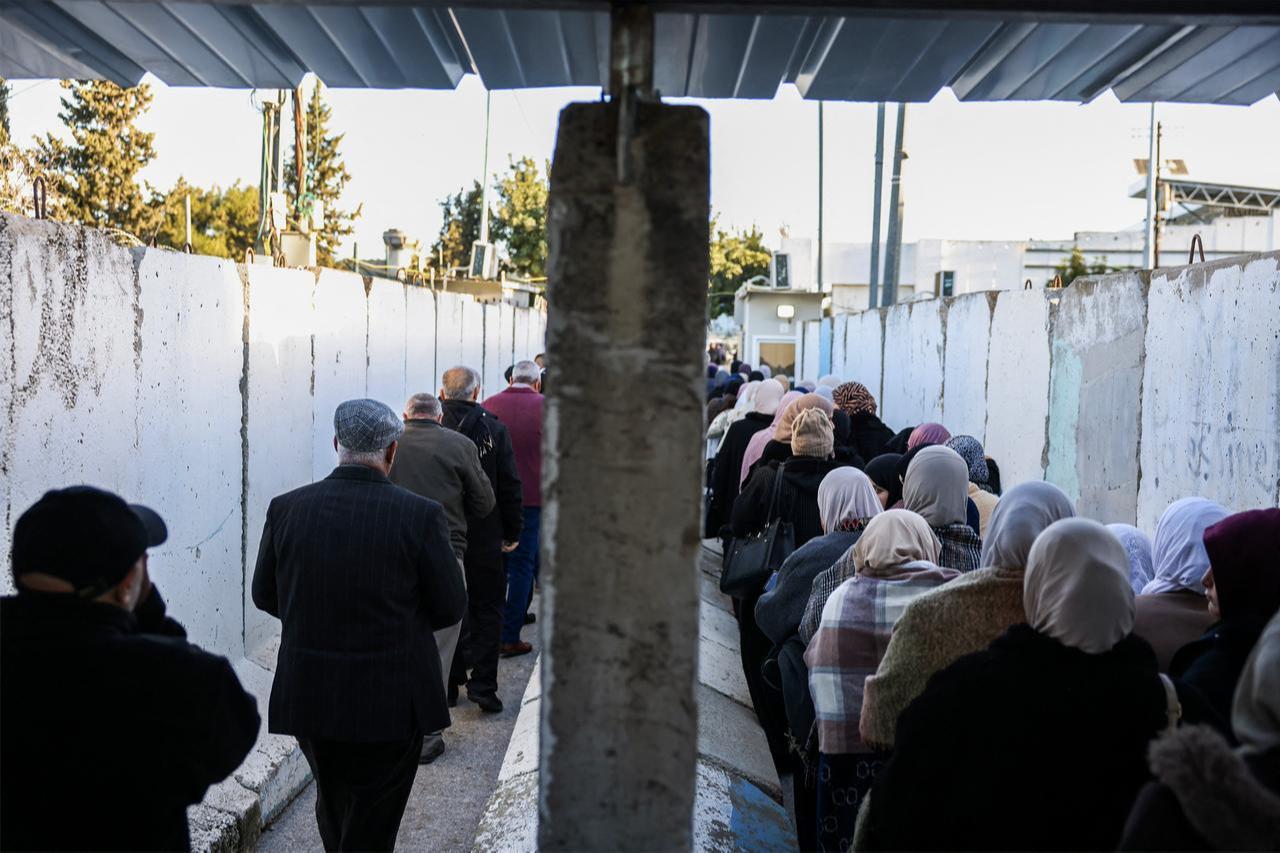 Palestinian Muslims gather at a checkpoint in the occupied West Bank city of Bethlehem on Feb. 20, 2026. (AFP Photo)