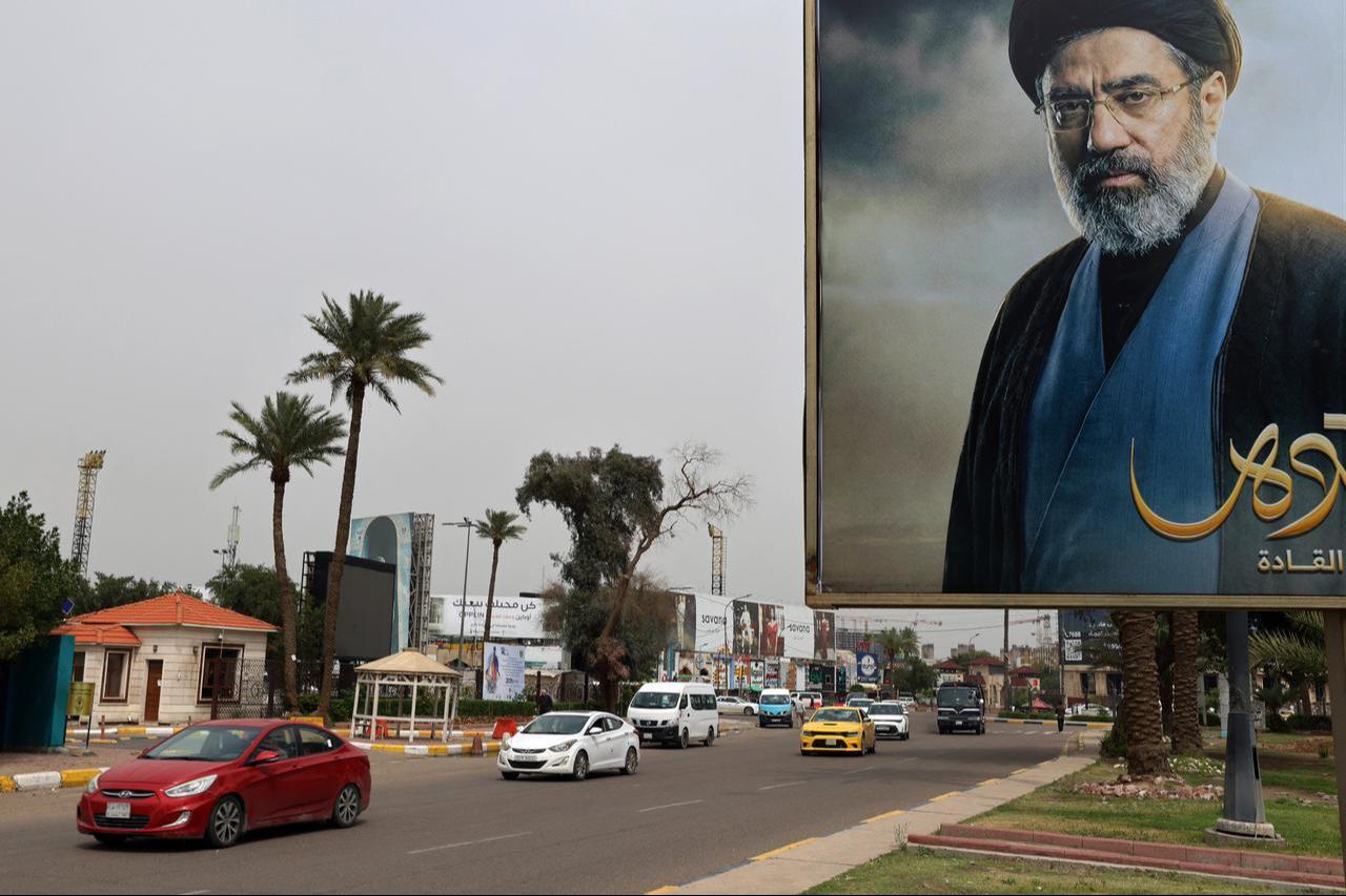 Cars drive past a billboard bearing an image of Iranian Supreme Leader Mojtaba Khamenei near the Iraqi Intelligence Directorate in the Mansour district of Baghdad, March 21, 2026. (AFP Photo)