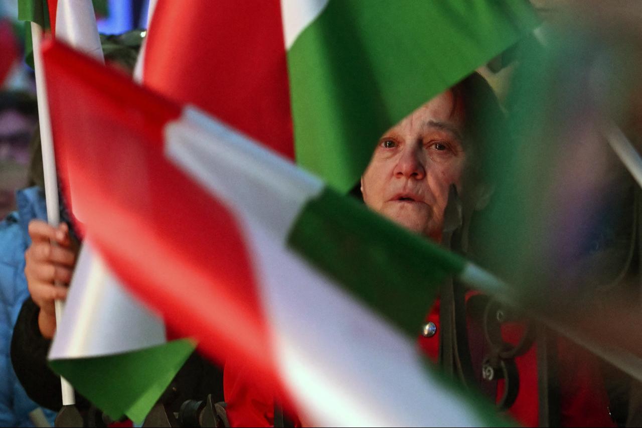 Supporters of Hungarian Prime Minister Viktor Orban hold Hungarian flags as they listen to his speech at Szentendre town on March 20, 2026. (AFP Photo)