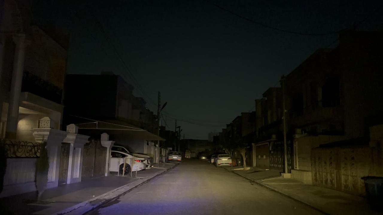 A residential street lies largely in darkness as power outages hit Erbil, Iraq, March 13, 2026. (AA Photo)