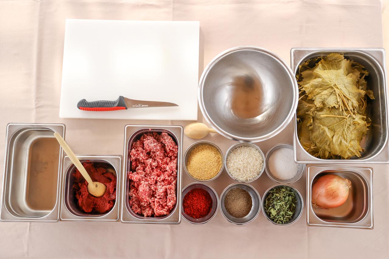 Ingredients used in Konya-style meat-stuffed vine leaves, including vine leaves, minced meat, tomato paste and spices, are displayed in Konya, Türkiye, March 20, 2026. (AA Photo)