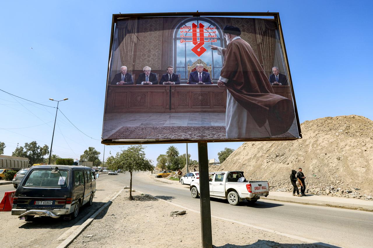 A billboard depicting Ali Khamenei, Iran's late supreme leader who was killed on February 28 in a US-Israeli strike in Tehran, confronting former US president Joe Biden, Former UK prime minister Boris Johnson, French President Emmanuel Macron, US President Donald Trump, and Israeli Prime Minister Benjamin Netanyahu, is displayed along a road in the Ameriyah neighbourhood in western Baghdad on March 18, 2026. (AFP Photo)