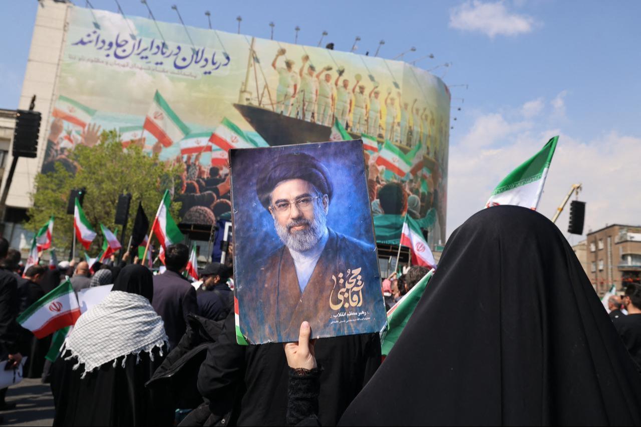 A mourner holds a picture depicting Iran's supreme leader Mojtaba Khamenei during the funeral of Iran's security chief Ali Larijani and Gholamreza Soleimani, in Tehran, March 18, 2026. (AFP Photo)
