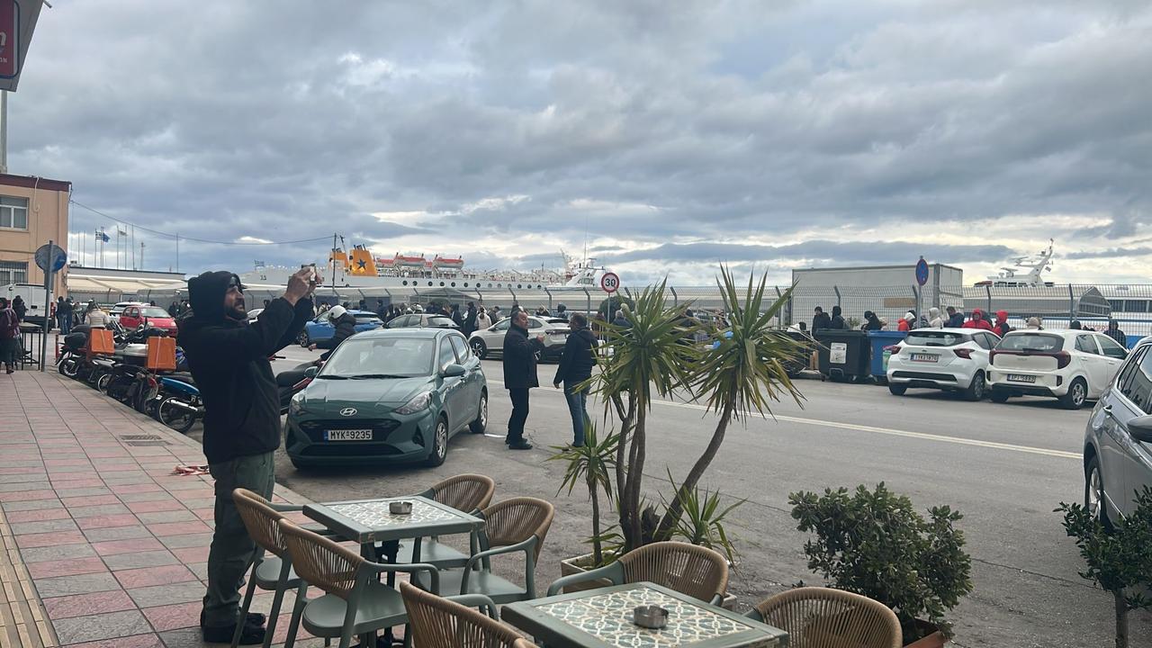 People gather along the roadside near Lesbos Port as ferry operations are delayed amid ongoing protests, March 21, 2026. (IHA Photo)