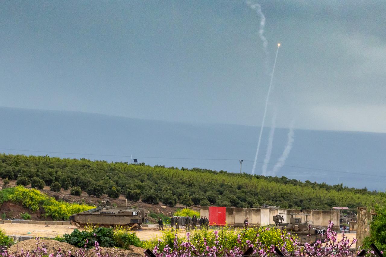 Iron Dome interceptors go up behind a group of Israeli soldiers along the border with Lebanon, in the Upper Galilee in northern Israel, March 21, 2026. (AFP Photo)