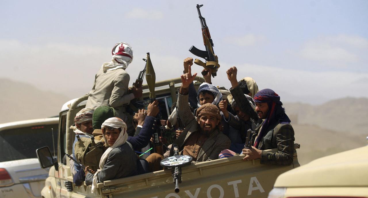 Armed Yemeni men raise their weapons as they gather near the capital Sanaa to show their support for the Shiite Houthis, February 21, 2019. (AFP Photo)