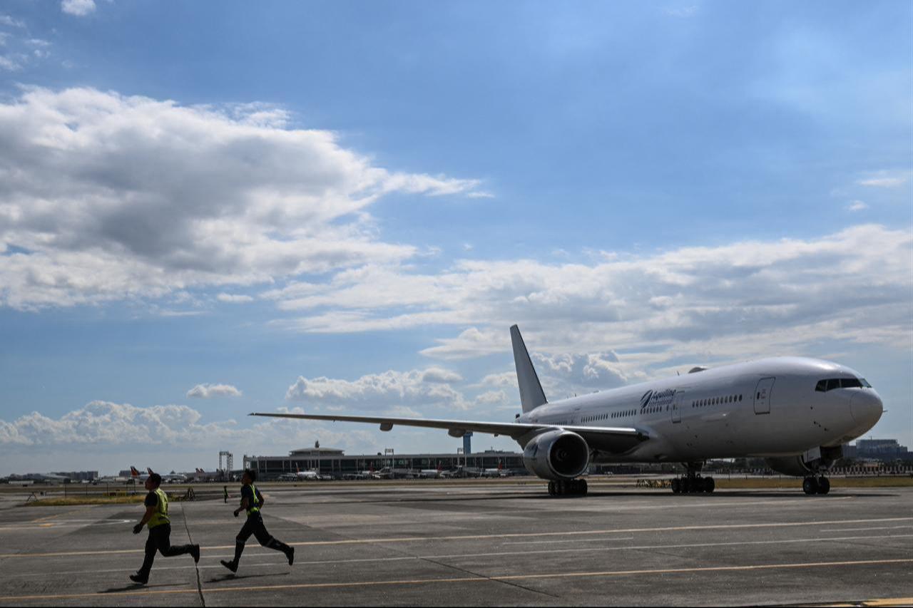 A government-chartered plane carrying Filipinos fleeing the war in the Middle East arrives from Dubai at Villamor Air Base in Pasay, Metro Manila, on March 19, 2026. (AFP Photo)