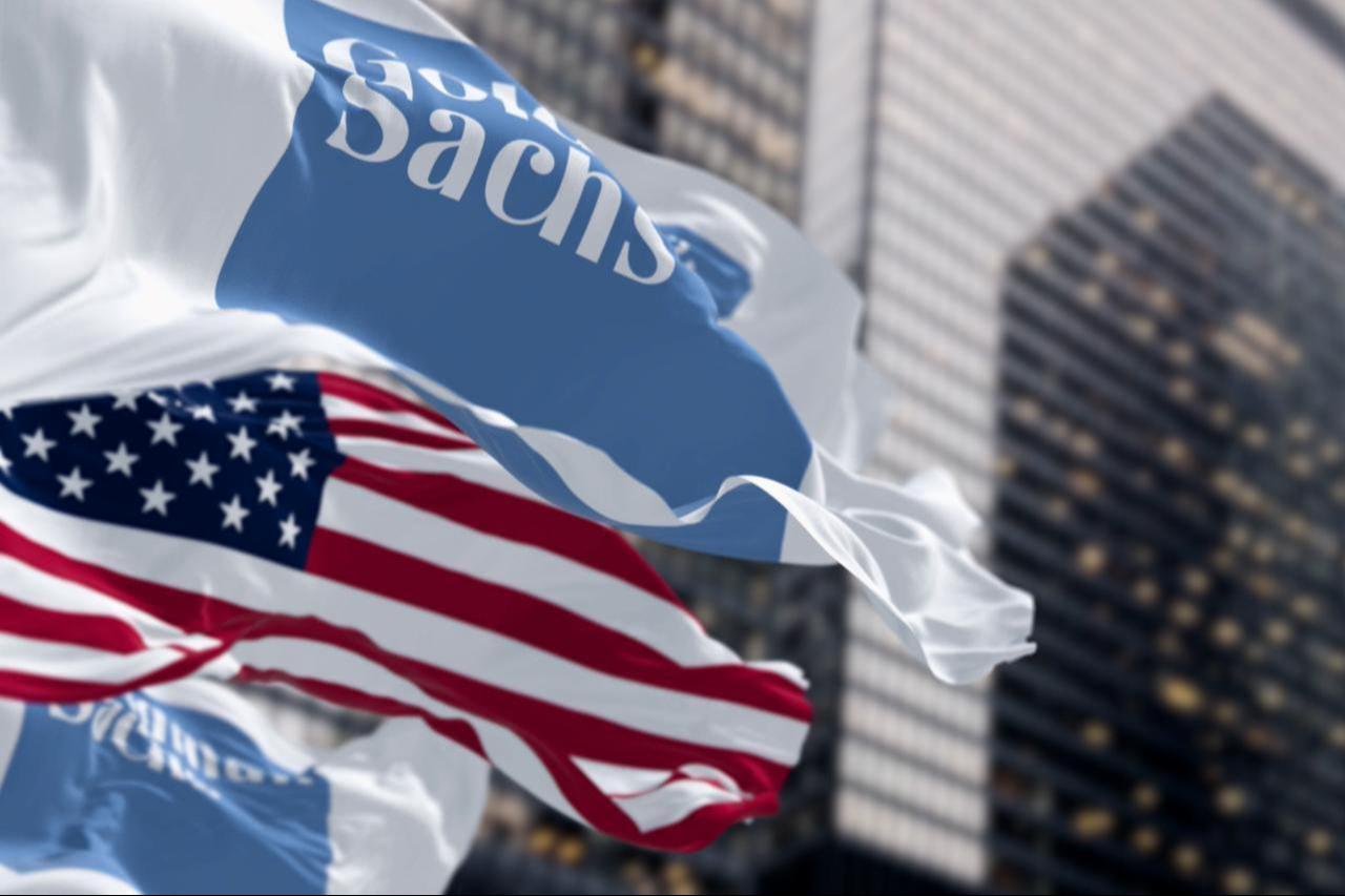 The flags of Goldman Sachs and the United States wave in front of a high-rise building in New York City, US, August 1, 2025. (Adobe Stock Photo)