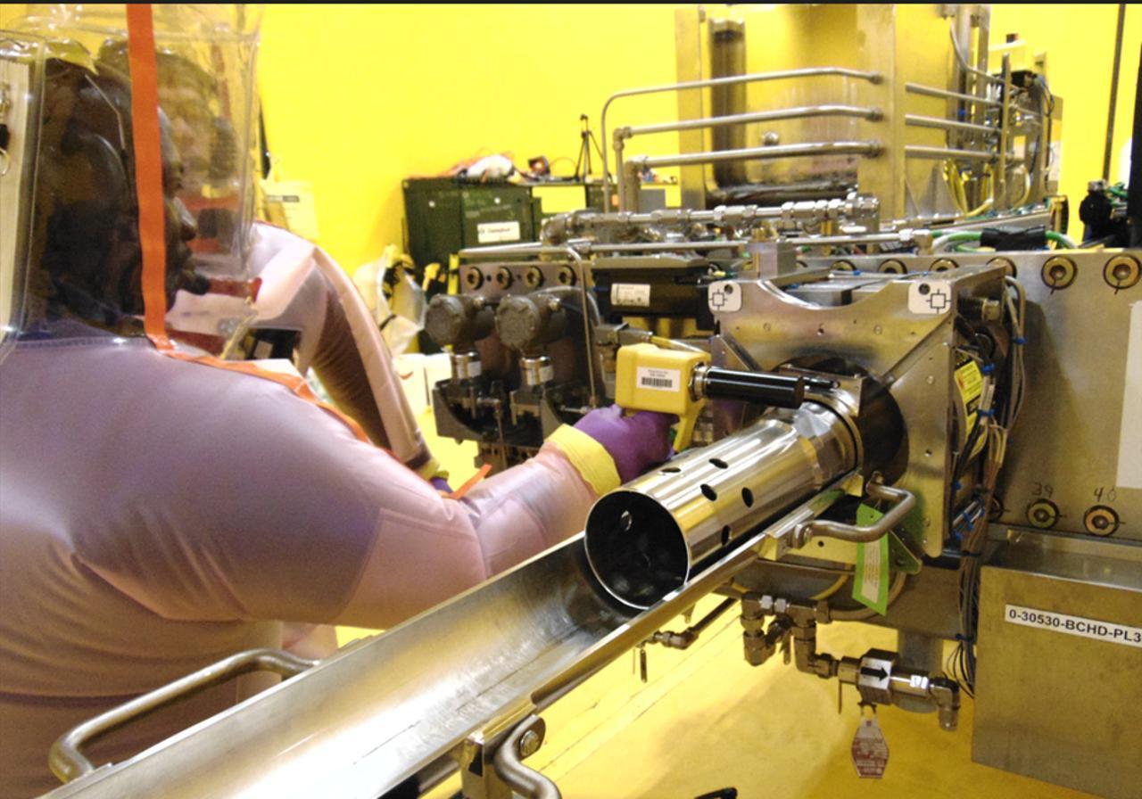 A technician operates nuclear equipment at a facility in Ontario, Canada. (Photo via kinectrics.com)