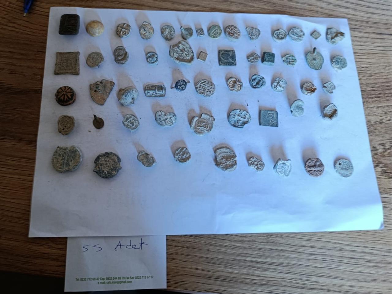 Various small artifacts, including seals and decorative pieces, are shown after being intercepted at a port inspection in Izmir, Türkiye, March 17, 2026. (AA Photo)
