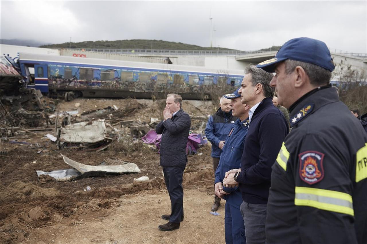 A handout image from the Greek Prime Minister’s Press Office captures Prime Minister Kyriakos Mitsotakis (second from right) and Minister of Infrastructure and Transport Kostas Karamanlis (left) at the site of a train collision near Larissa, Greece. Minister Karamanlis resigned later that day, March 1, 2023. (Photo via EPA)