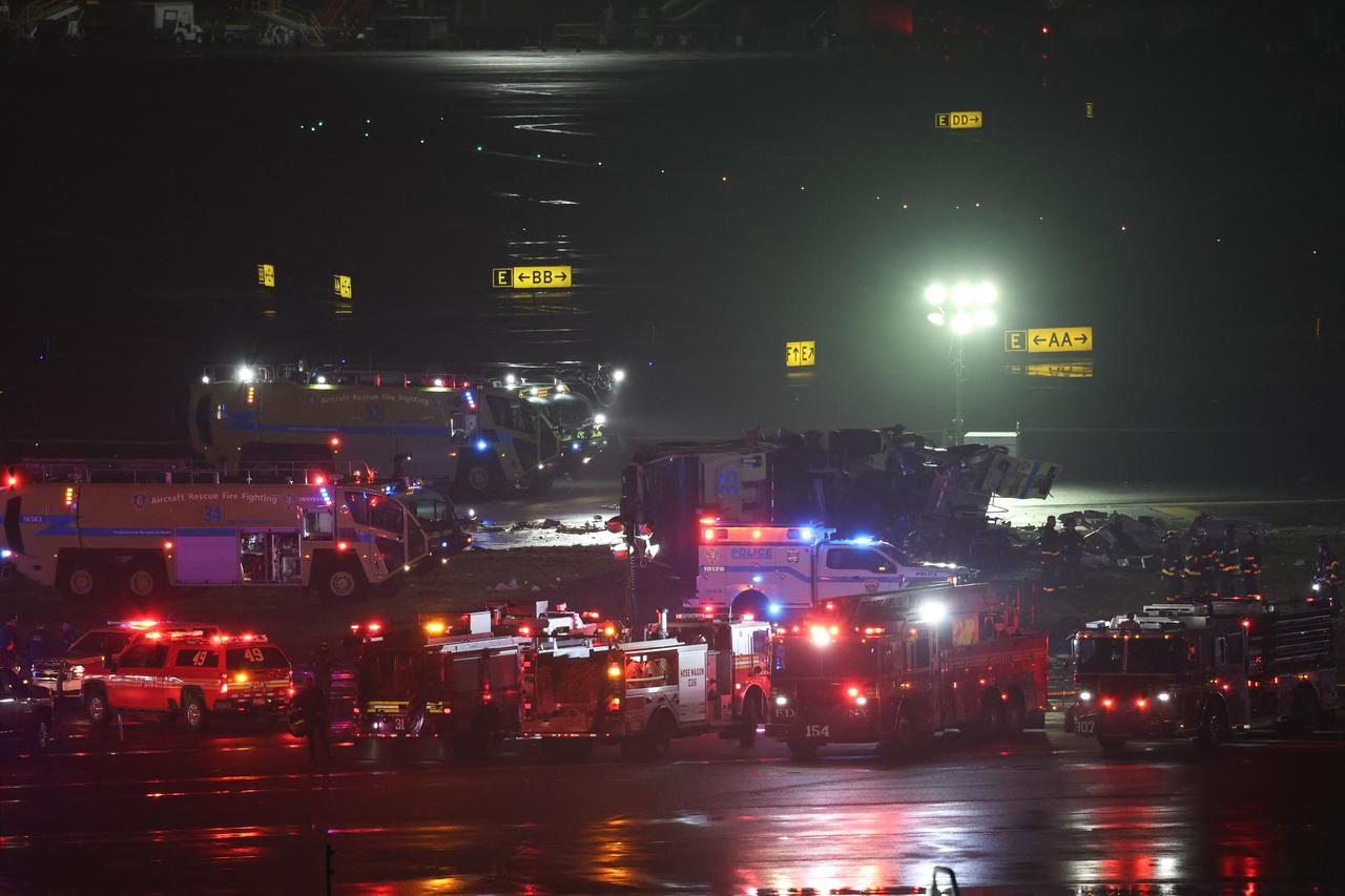 Emergency personnel respond to an Air Canada Express CRJ-900 after colliding with a Port Authority fire truck at LaGuardia Airport in New York,  March 23, 2026. (AFP Photo)