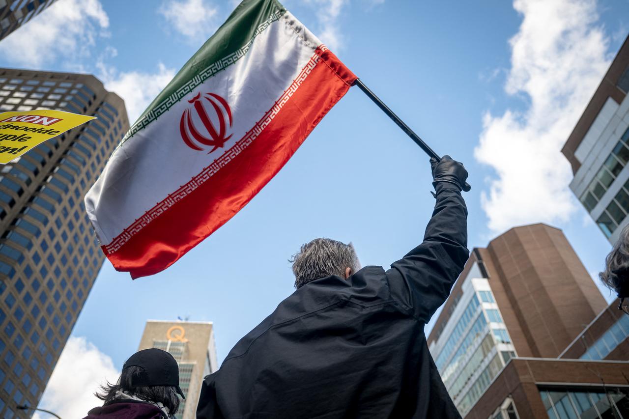 A demonstrator waves an Iranian flag while protesting against the United States and Israel for initiating the Middle East war in Montreal, Quebec, Canada, March 21, 2026. (AFP Photo)