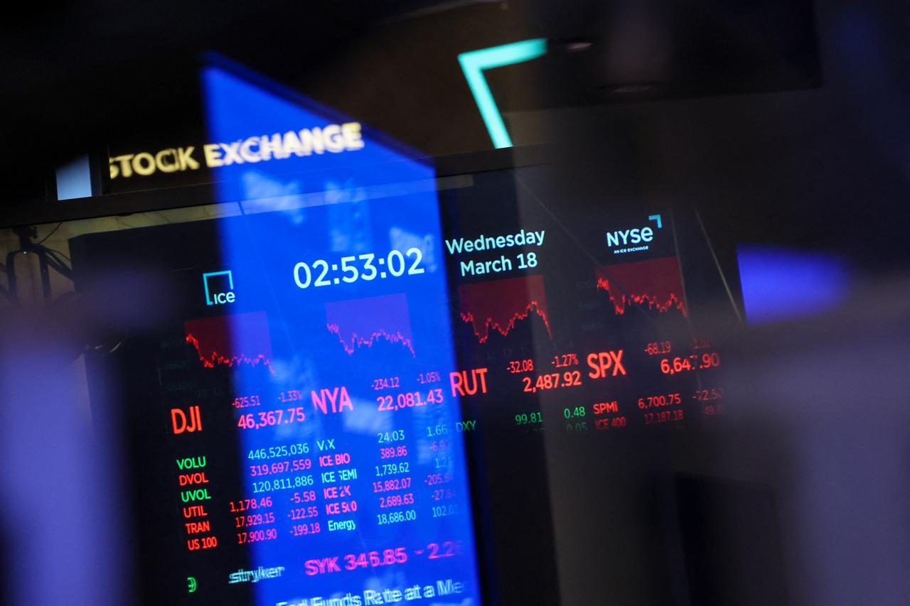 Stock tickers and market numbers are displayed on a monitor on the floor of the New York Stock Exchange (NYSE) in New York, March 18, 2026. (AFP Photo)