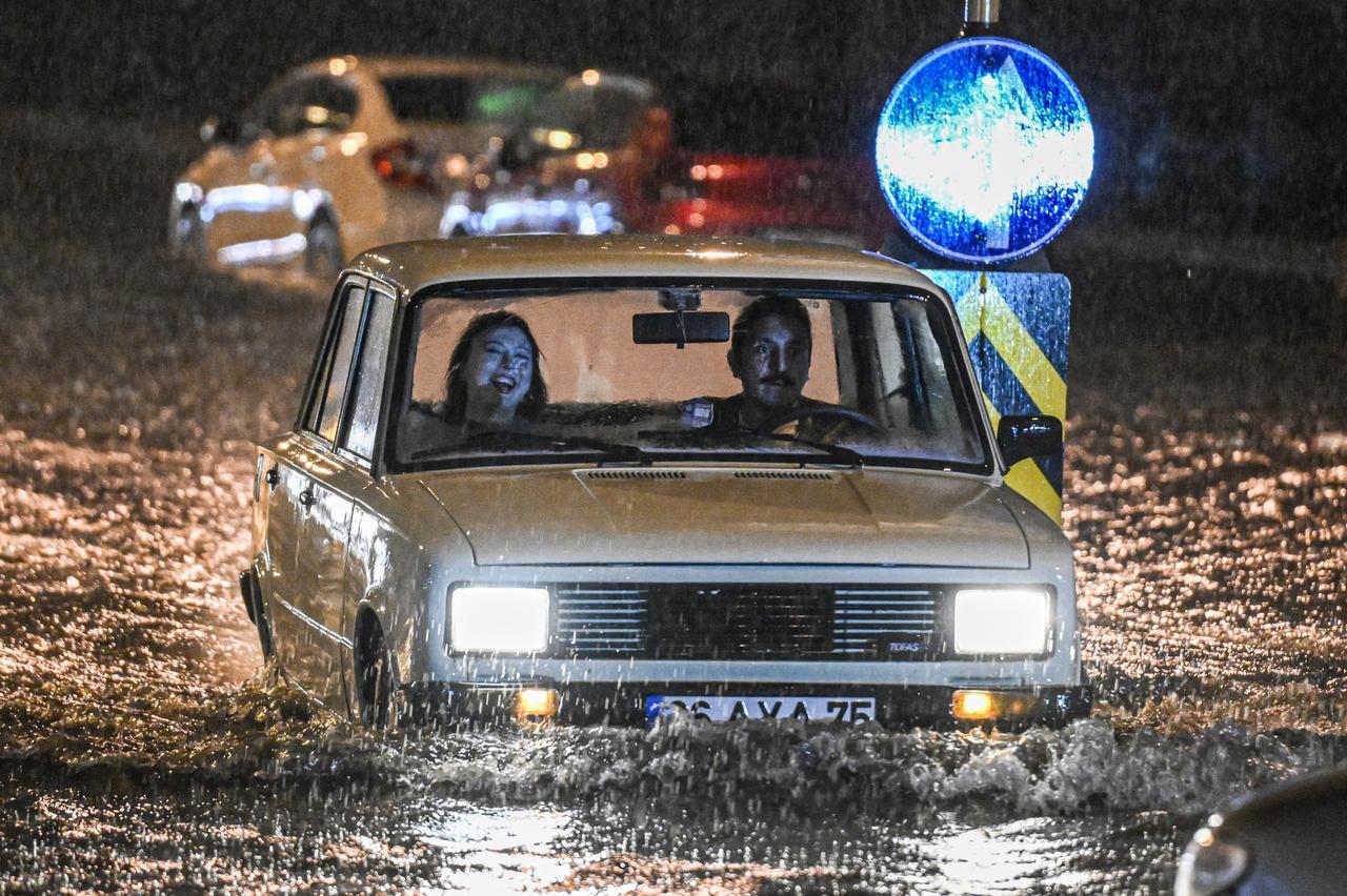 Vehicles struggle to move through a flooded street following torrential rain and hail in Ankara, Türkiye, April 4, 2025. (AA Photo)