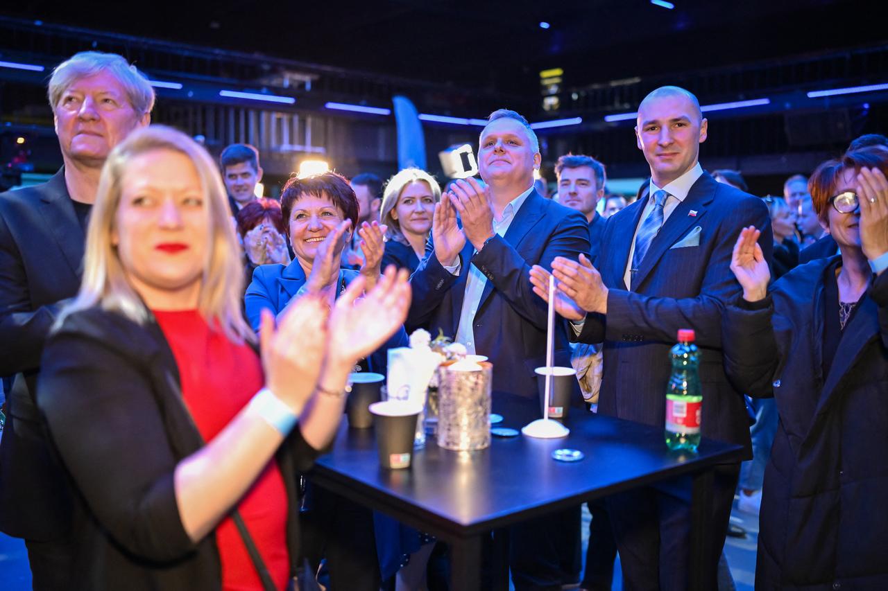 Supporters of Gibanje Svoboda (The Freedom Movement) with Minister of the Environment, Climate and Energy Bojan Kumer (3rd R) react after exit polls results of the Parliamentary Elections in Ljubljana, on March 22, 2026. (AFP Photo)