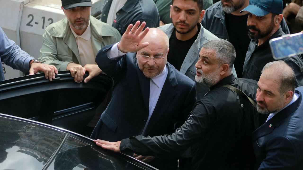 Iran's Parliament Speaker Mohammad Bagher Ghalibaf (C) waves as he returns to his car after visiting the site of an Israeli airstrike that targeted Beirut's Basta neighbourhood, Oct. 12, 2024. (AFP Photo)