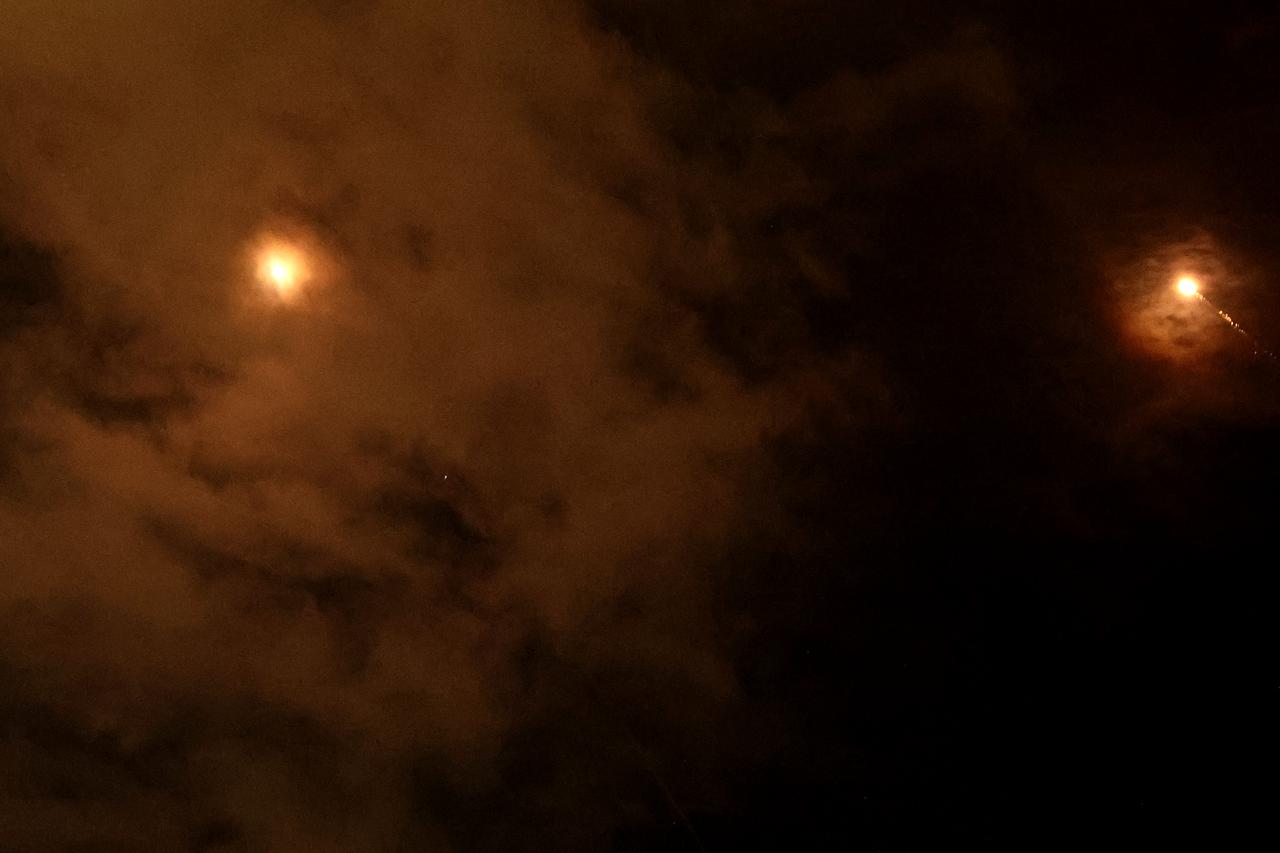 Rocket trails are seen in the sky above the Israeli coastal city of Netanya amid a fresh barrage of Iranian missile attacks, March 25, 2026. (AFP Photo)
