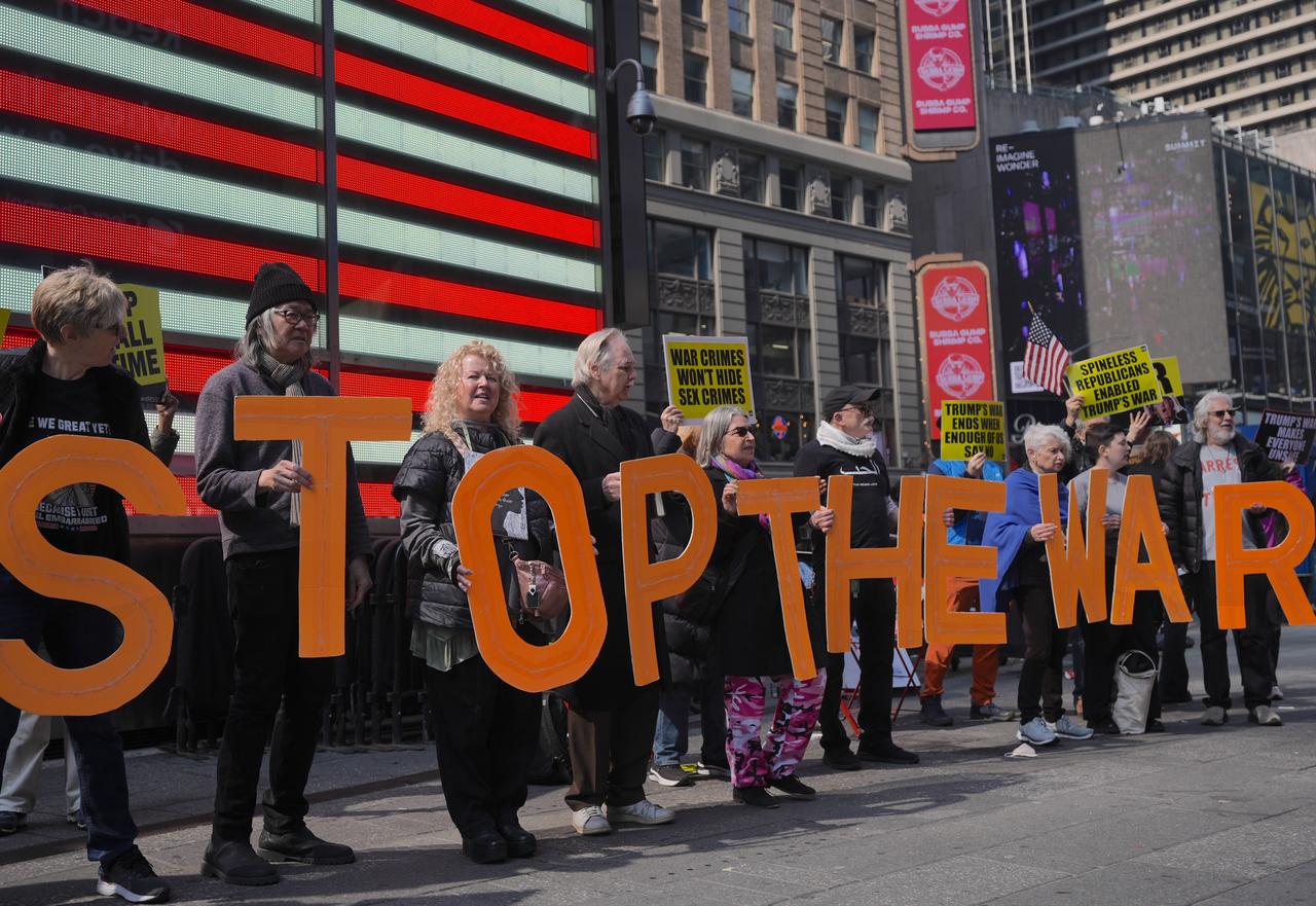 Demonstrators hold a protest against the war on Iran next to Recruting Station in Times Square, New York City, United States, on Sunday, March 22, 2026. (AA Photo)