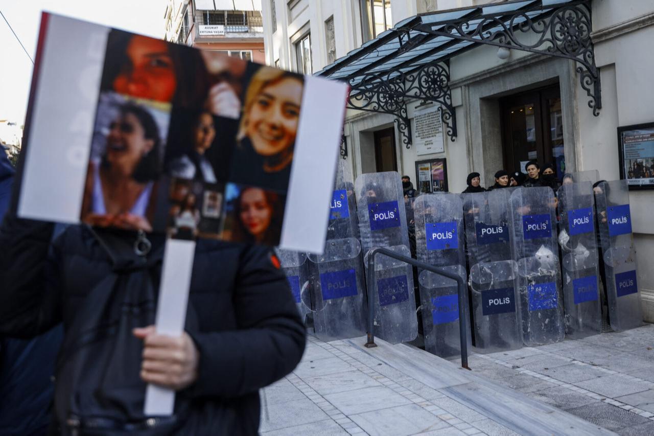 A protester holds portraits of Turkish women who were victims of violence during a demonstration for the International Day for Elimination of Violence against Women, in Istanbul on Nov. 25, 2024. (AFP Photo)