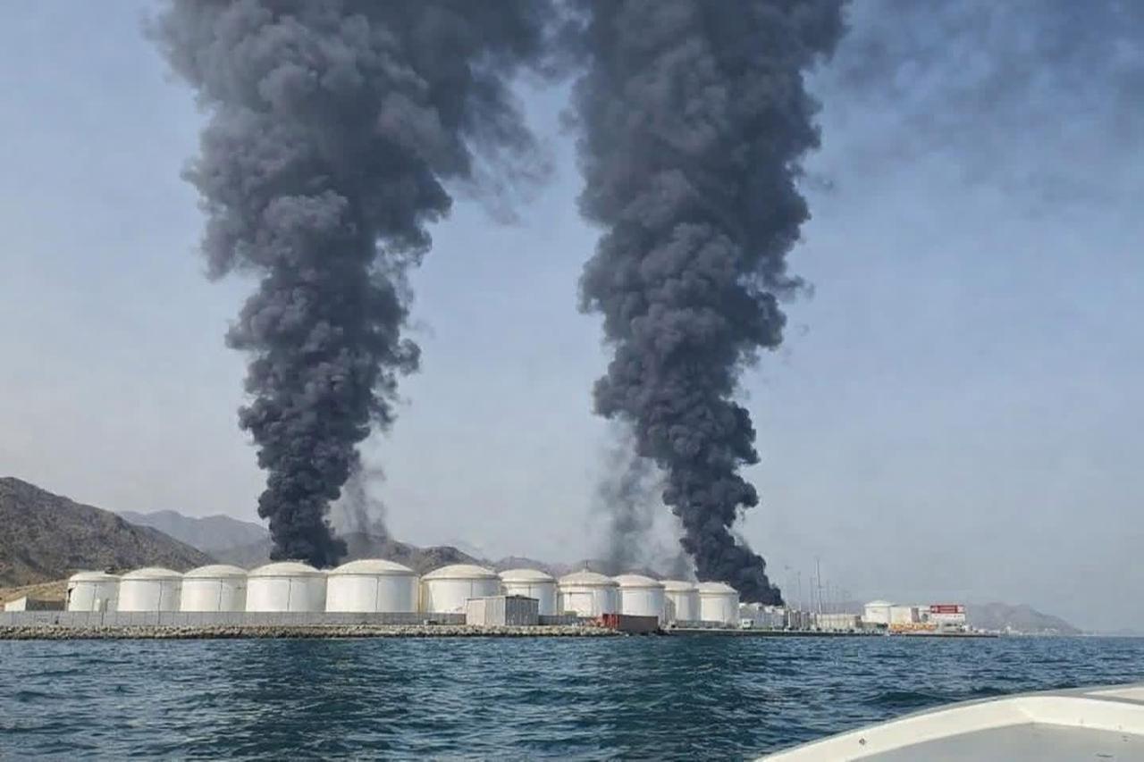 On the image, smoke plumes billow from the Fujairah oil terminal following a suspected drone strike on March 15, 2026. (Photo via Facebook)