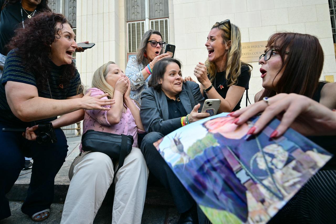 Laura Marquez-Garrett (C), plaintiffs' attorney for SMVLC (Social Media Victims Law Center) and victims' family members react to news that the jury has found Meta and YouTube liable in the social media addiction trial, United States, March 25, 2026. (AFP Photo)