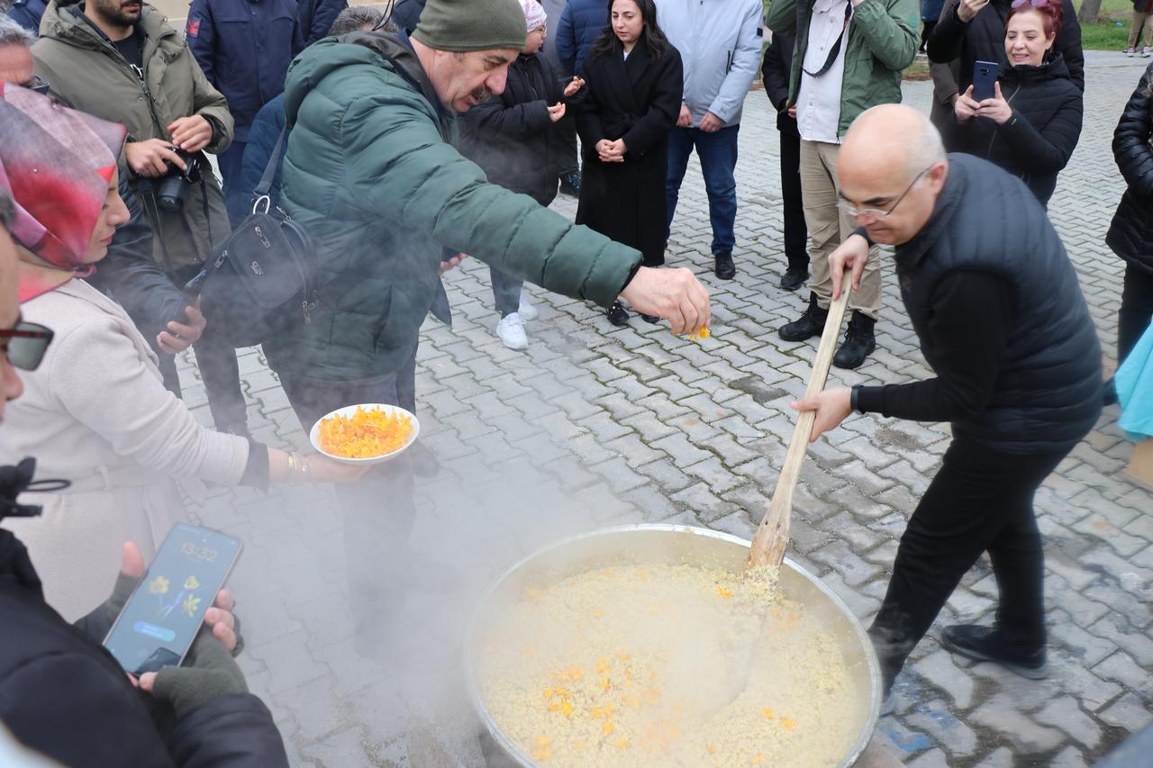 Locals add freshly gathered crocus flowers to a large cauldron as part of the traditional “Cigdem Gezmesi” ritual in Bogazkale, Corum, Türkiye, March 26, 2026. (AA Photo)