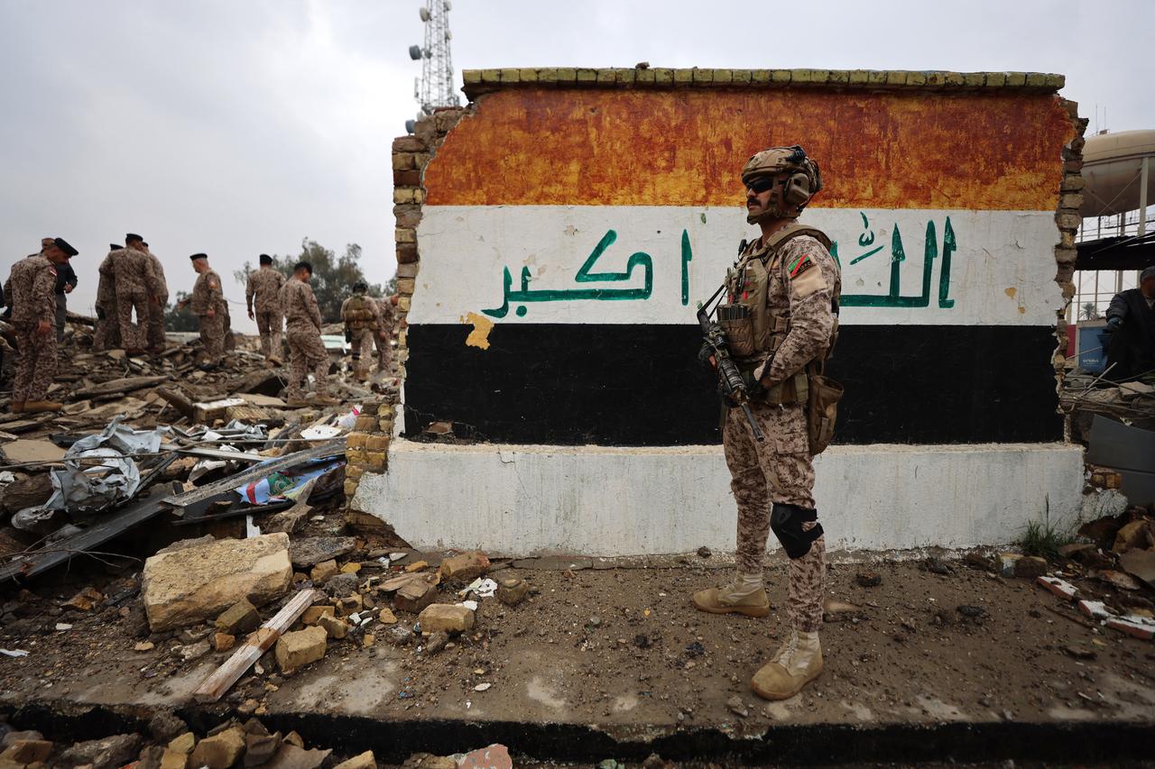 Iraqi soldiers inspect the site of a destroyed healthcare center in the Habbaniyah military base, in Habbaniyah, west of Baghdad, Iraq on March 26, 2026. (AFP Photo)