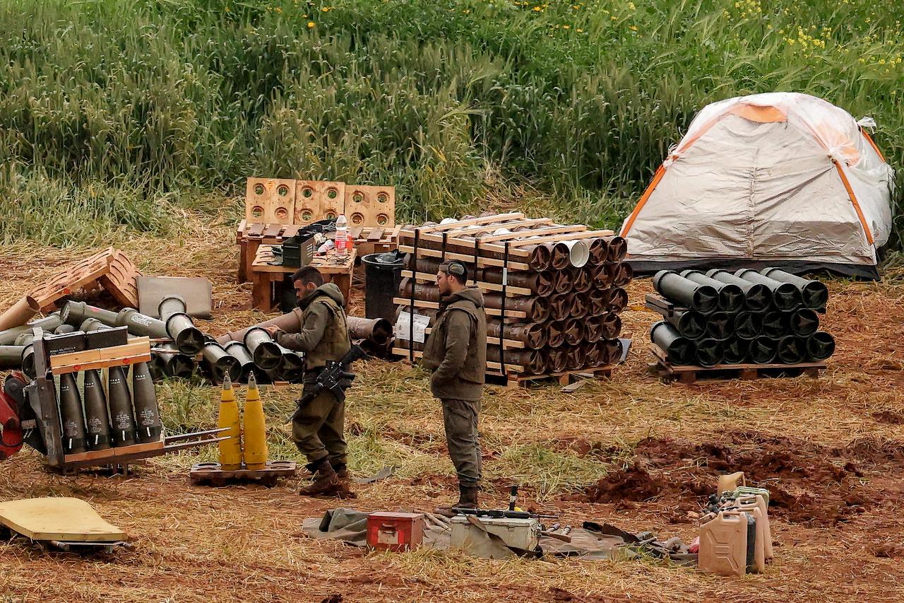 Israeli army soldiers stand by artillery shell stocks at a position in the upper Galilee in northern Israel near the border with southern Lebanon on March 26, 2026. (AFP Photo)