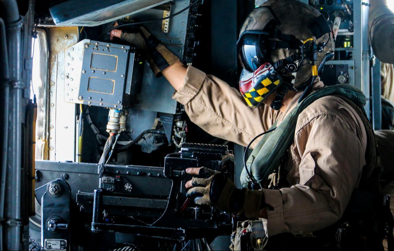 U.S. Marine Corps Gunnery, a CH-53E Super Stallion aerial observer scans the open seas during flight operations in the U.S. 5th fleet area of operations, June 13, 2018. (Photo via U.S. Marine Corps)