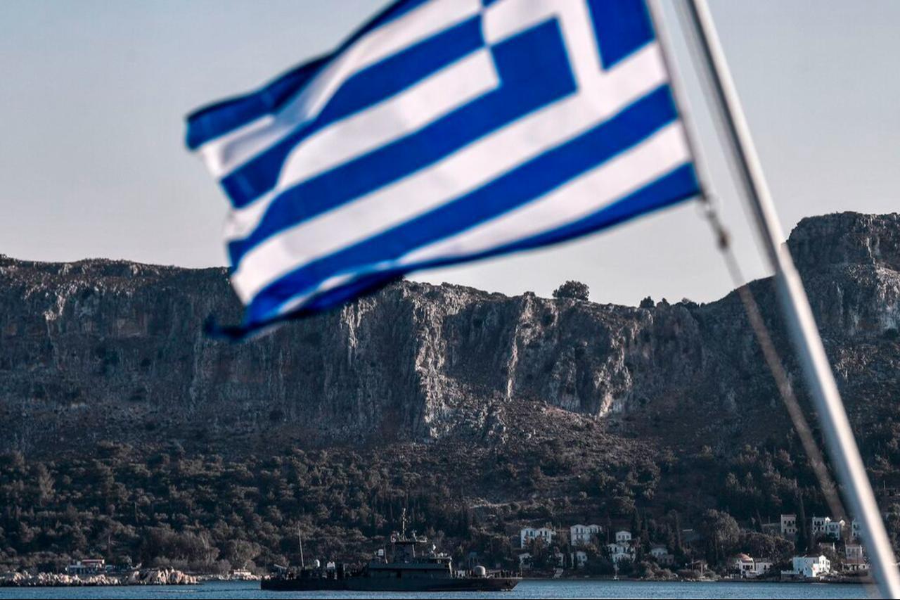 The Greek Navy Roussen or Super Vita class Fast Missile Patrol Boat P 71 HS Ritsos patrols off the tiny island of Kastellorizo (Megisti) in front of a Greek flag, on August 28, 2020. (AFP Photo)