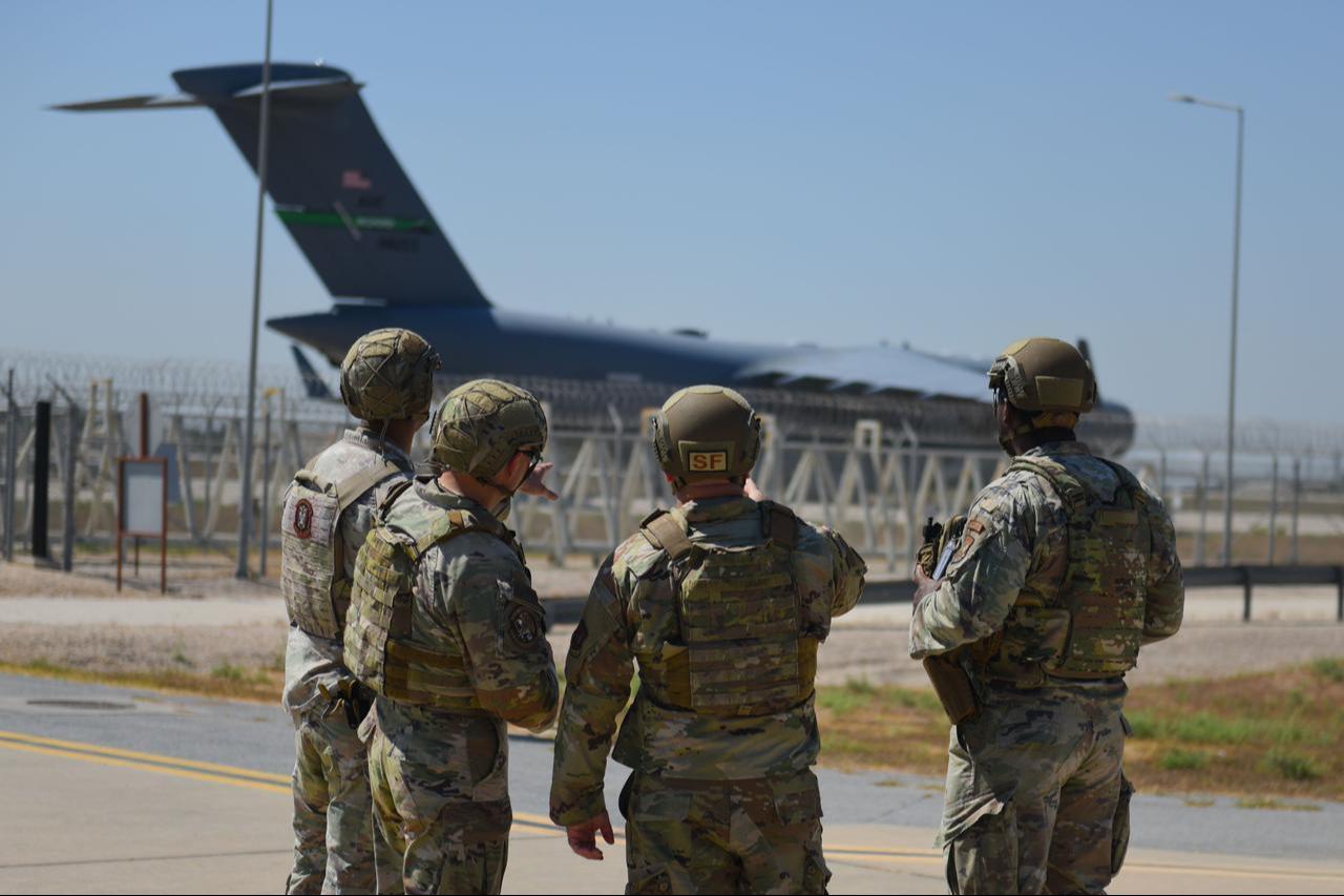 US Air Force 39th Security Forces Squadron Airmen discuss security logistics in front of a C-17 Globemaster III during exercise Titan Shield 25-08 at Incirlik Air Base, Türkiye, Aug. 12, 2025. (Photo via US Air Force)