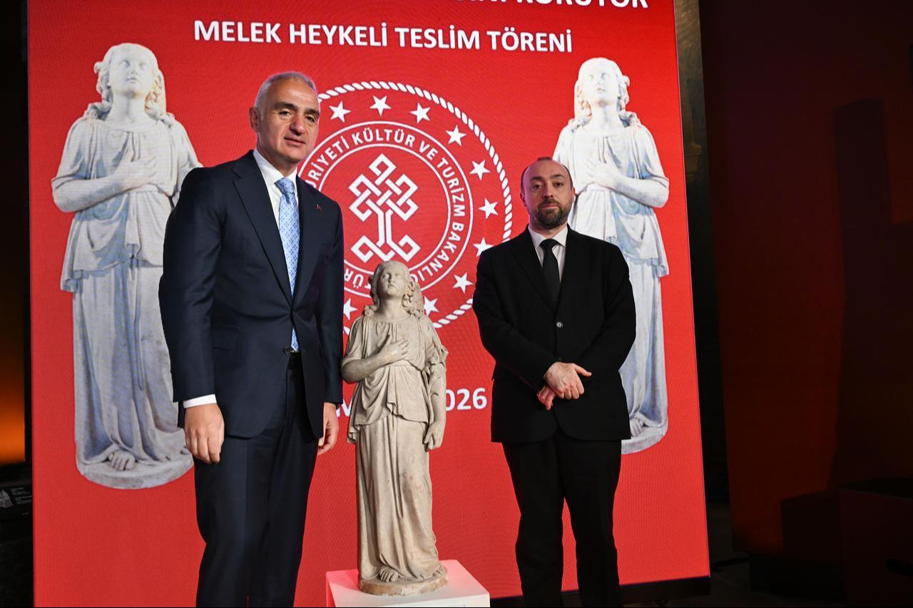 Culture and Tourism Minister Mehmet Nuri Ersoy and a representative of the Greek Orthodox Patriarchate pose with the returned “angel statue” during the official ceremony in Istanbul, Türkiye, March 27, 2026. (AA Photo)