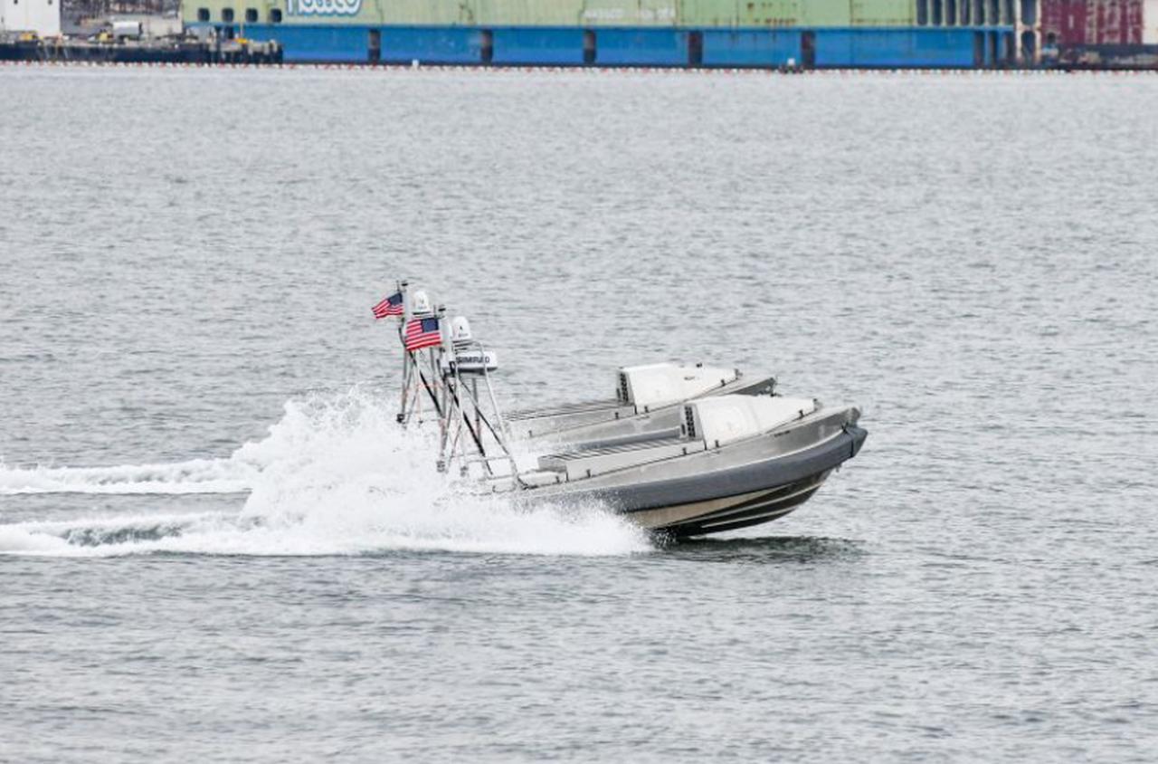 An unmanned surface vessel equipped with U.S. flags moves across coastal waters. (Photo via blacksea.tech)